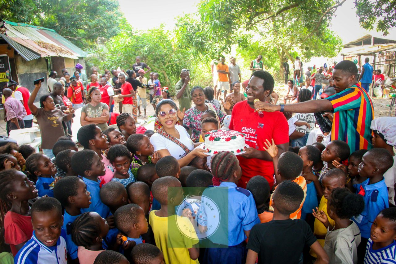 Foundation volunteers and children celebrating together at Christmas Memories
