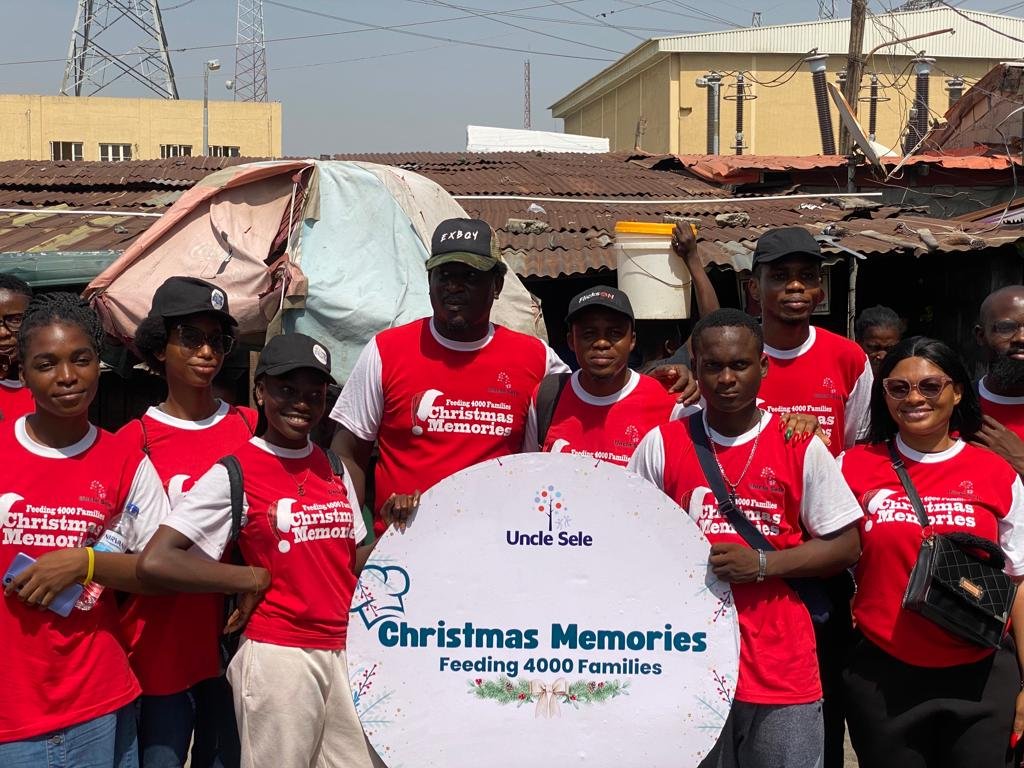 Uncle Sele Foundation Christmas Memories team holding a Feeding 4000 Families sign