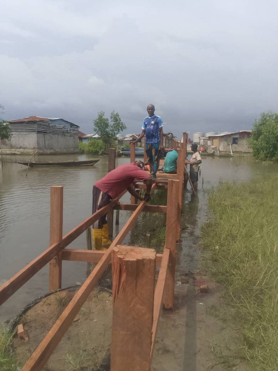 Workers assembling the wooden supporting frame over the water