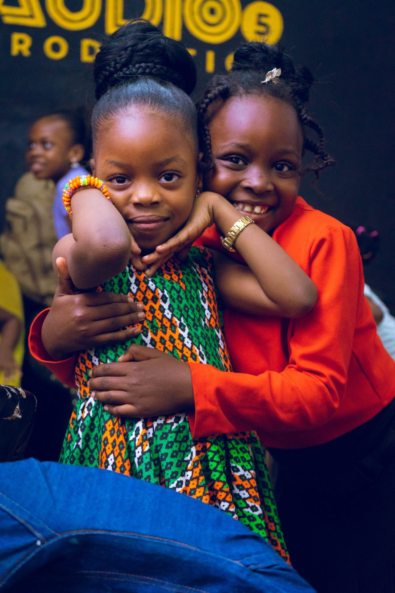 Two girls embracing at a Little Miss Rainbow event